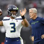 LAS VEGAS, NEVADA - AUGUST 14:  Quarterback Russell Wilson #3 warms up while head coach Pete Carroll of the Seattle Seahawks looks on before a preseason game against the Las Vegas Raiders at Allegiant Stadium on August 14, 2021 in Las Vegas, Nevada. (Photo by Chris Unger/Getty Images)