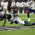 LAS VEGAS, NEVADA - AUGUST 14: Wide receiver DJ Turner #19 of the Las Vegas Raiders is tackled by cornerback Tre Flowers #21 of the Seattle Seahawks during a preseason game at Allegiant Stadium on August 14, 2021 in Las Vegas, Nevada. (Photo by Chris Unger/Getty Images)