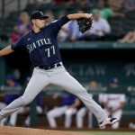 ARLINGTON, TEXAS - AUGUST 19: Chris Flexen #77 of the Seattle Mariners pitches against the Texas Rangers in the bottom of the first inning at Globe Life Field on August 19, 2021 in Arlington, Texas. (Photo by Tom Pennington/Getty Images)