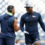 SEATTLE, WASHINGTON - AUGUST 21: Quarterback Russell Wilson #3 of the Seattle Seahawks and outside linebacker Von Miller #58 of the Denver Broncos greet one another before an NFL preseason game at Lumen Field on August 21, 2021 in Seattle, Washington. (Photo by Steph Chambers/Getty Images)