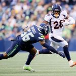 SEATTLE, WASHINGTON - AUGUST 21: Running back Royce Freeman #28 of the Denver Broncos rushes against linebacker Jordyn Brooks #56 of the Seattle Seahawks during the first quarter in an NFL preseason game at Lumen Field on August 21, 2021 in Seattle, Washington. (Photo by Steph Chambers/Getty Images)