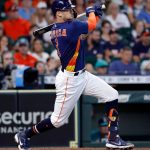 HOUSTON, TEXAS - AUGUST 22: Carlos Correa #1 of the Houston Astros doubles in the third inning against the Seattle Mariners at Minute Maid Park on August 22, 2021 in Houston, Texas. (Photo by Bob Levey/Getty Images)
