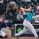 HOUSTON, TEXAS - AUGUST 22: Kyle Seager #15 of the Seattle Mariners hits a three-run home run in the 11th inning against the Houston Astros at Minute Maid Park on August 22, 2021 in Houston, Texas. (Photo by Bob Levey/Getty Images)