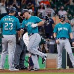 HOUSTON, TEXAS - AUGUST 22: Kyle Seager #15 of the Seattle Mariners is congratulated by Ty France #23 after hitting a three-run home run in the 11th inning against the Houston Astros at Minute Maid Park on August 22, 2021 in Houston, Texas. (Photo by Bob Levey/Getty Images)