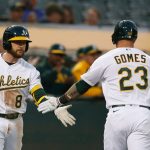 OAKLAND, CALIFORNIA - AUGUST 23: Yan Gomes #23 of the Oakland Athletics celebrates with Jed Lowrie #8 after hitting a solo home run in the bottom of the fourth inning against the Seattle Mariners at RingCentral Coliseum on August 23, 2021 in Oakland, California. (Photo by Lachlan Cunningham/Getty Images)
