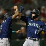 OAKLAND, CALIFORNIA - AUGUST 23: Mitch Haniger #17 of the Seattle Mariners celebrates with J.P. Crawford #3 after hitting a two-run home run in the top of the sixth inning against the Oakland Athletics at RingCentral Coliseum on August 23, 2021 in Oakland, California. (Photo by Lachlan Cunningham/Getty Images)