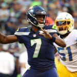 SEATTLE, WASHINGTON - AUGUST 28: Geno Smith #7 of the Seattle Seahawks looks to throw the ball while pressured by Emeke Egbule #51 of the Los Angeles Chargers in the first quarter during the NFL preseason game at Lumen Field on August 28, 2021 in Seattle, Washington. (Photo by Abbie Parr/Getty Images)