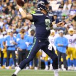 SEATTLE, WASHINGTON - AUGUST 28: Sean Mannion #9 of the Seattle Seahawks passes the ball against the Los Angeles Chargers in the fourth quarter during the NFL preseason game at Lumen Field on August 28, 2021 in Seattle, Washington. (Photo by Abbie Parr/Getty Images)