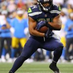 SEATTLE, WASHINGTON - AUGUST 28: Josh Johnson #34 of the Seattle Seahawks carries the ball against the Los Angeles Chargers in the fourth quarter during the NFL preseason game at Lumen Field on August 28, 2021 in Seattle, Washington. (Photo by Abbie Parr/Getty Images)