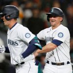 SEATTLE, WASHINGTON - AUGUST 30: Dylan Moore #25 and Kyle Seager #15 of the Seattle Mariners reacts after Moore's two run home run against the Houston Astros during the sixth inning at T-Mobile Park on August 30, 2021 in Seattle, Washington. (Photo by Steph Chambers/Getty Images)