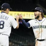 SEATTLE, WASHINGTON - AUGUST 31: Yusei Kikuchi #18 and J.P. Crawford #3 of the Seattle Mariners react during the seventh inning against the Houston Astros at T-Mobile Park on August 31, 2021 in Seattle, Washington. (Photo by Steph Chambers/Getty Images)