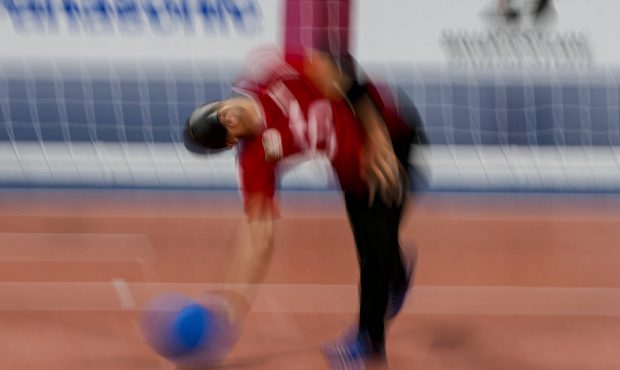 Algeria's Djalal Boutadjine throws the ball during a men's preliminary goal ball match against Japa...