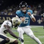 
              Jacksonville Jaguars quarterback Trevor Lawrence (16) tries to avoid a hit by New Orleans Saints cornerback Paulson Adebo in the first half of an NFL preseason football game in New Orleans, Monday, Aug. 23, 2021. (AP Photo/Derick Hingle)
            