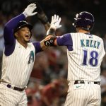 PHOENIX, AZ - SEPTEMBER 04: Carson Kelly #18 of the Arizona Diamondbacks high fives teammate Ketel Marte #4 after hitting a two-run home run during the first inning of the MLB game against the Seattle Mariners at Chase Field on September 4, 2021 in Phoenix, Arizona. (Photo by Kelsey Grant/Getty Images)
