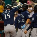 PHOENIX, AZ - SEPTEMBER 04: Kyle Seager #15 of the Seattle Mariners celebrates with Luis Torrens #22 and J.P. Crawford #3 after hitting a three-run home run in the sixth inning of the MLB game against the Arizona Diamondbacks at Chase Field on September 4, 2021 in Phoenix, Arizona. (Photo by Kelsey Grant/Getty Images)