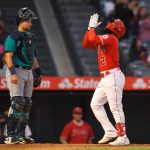 ANAHEIM, CA - SEPTEMBER 25:  Cal Raleigh #29 of the Seattle Mariners looks on as Luis Rengifo #2 of the Los Angeles Angels crosses the plate after hitting a home run in the second inning at Angel Stadium of Anaheim on September 25, 2021 in Anaheim, California. (Photo by John McCoy/Getty Images)
