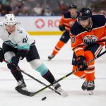 EDMONTON, AB - SEPTEMBER 28: Ryker Evans #41 of the Seattle Kraken skates against Colton Sceviour #70 of the Edmonton Oilers during the second period in a preseason game at Rogers Place on September 28, 2021 in Edmonton, Canada. (Photo by Codie McLachlan/Getty Images)