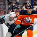 EDMONTON, AB - SEPTEMBER 28: Evan Bouchard #75 of the Edmonton Oilers battles against Morgan Geekie #67 of the Seattle Kraken during the third period of pre-season action at Rogers Place on September 28, 2021 in Edmonton, Canada. (Photo by Codie McLachlan/Getty Images)