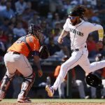 SEATTLE, WASHINGTON - SEPTEMBER 01: J.P. Crawford #3 of the Seattle Mariners scores a run past Martin Maldonado #15 of the Houston Astros during the sixth inning at T-Mobile Park on September 01, 2021 in Seattle, Washington. (Photo by Steph Chambers/Getty Images)