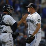 SEATTLE, WASHINGTON - SEPTEMBER 01: Tom Murphy #2 and Paul Sewald #37 of the Seattle Mariners react after the final out to beat the Houston Astros 1-0 at T-Mobile Park on September 01, 2021 in Seattle, Washington. (Photo by Steph Chambers/Getty Images)