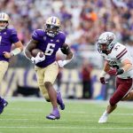 SEATTLE, WASHINGTON - SEPTEMBER 04: Richard Newton #6 of the Washington Huskies carries the ball against Montana Grizzlies during the second quarter at Husky Stadium on September 04, 2021 in Seattle, Washington. (Photo by Steph Chambers/Getty Images)
