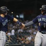 PHOENIX, ARIZONA - SEPTEMBER 05: Ty France #23 of the Seattle Mariners high fives Jarred Kelenic #10 after scoring a run against the Arizona Diamondbacks during the fourth inning of the MLB game at Chase Field on September 05, 2021 in Phoenix, Arizona. (Photo by Christian Petersen/Getty Images)