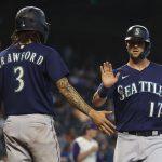 PHOENIX, ARIZONA - SEPTEMBER 05: Mitch Haniger #17 of the Seattle Mariners high fives J.P. Crawford #3 after scoring against the Arizona Diamondbacks during the 11th inning of the MLB game at Chase Field on September 05, 2021 in Phoenix, Arizona. (Photo by Christian Petersen/Getty Images)