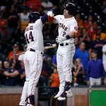 HOUSTON, TEXAS - SEPTEMBER 07: Alex Bregman #2 of the Houston Astros gives Yordan Alvarez #44 a high five after hitting a two run home run in the ninth inning against the Seattle Mariners at Minute Maid Park on September 07, 2021 in Houston, Texas. (Photo by Bob Levey/Getty Images)