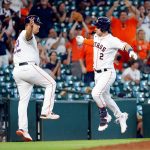 HOUSTON, TEXAS - SEPTEMBER 08: Alex Bregman #2 of the Houston Astros high fives Omar Lopez #22 after a home run in the ninth inning against the Seattle Mariners at Minute Maid Park on September 08, 2021 in Houston, Texas. (Photo by Bob Levey/Getty Images)