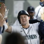 SEATTLE, WASHINGTON - SEPTEMBER 11: Jarred Kelenic #10 of the Seattle Mariners reacts in the dugout with teammates after his home run against the Arizona Diamondbacks during the fourth inning at T-Mobile Park on September 11, 2021 in Seattle, Washington. (Photo by Steph Chambers/Getty Images)