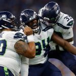 INDIANAPOLIS, INDIANA - SEPTEMBER 12: Rasheem Green #94 of the Seattle Seahawks celebrates with Bryan Mone #90 and Jamal Adams #33 after a sack against the Indianapolis Colts during the first quarter at Lucas Oil Stadium on September 12, 2021 in Indianapolis, Indiana. (Photo by Michael Hickey/Getty Images)