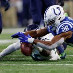 INDIANAPOLIS, INDIANA - SEPTEMBER 12: Jordyn Brooks #56 of the Seattle Seahawks and Jonathan Taylor #28 of the Indianapolis Colts dive for a fumbled ball during the second quarter at Lucas Oil Stadium on September 12, 2021 in Indianapolis, Indiana. (Photo by Michael Hickey/Getty Images)