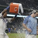 KANSAS CITY, MISSOURI - SEPTEMBER 18:  Salvador Perez #13 of the Kansas City Royals douses starting pitcher Kris Bubic #50 with water as they celebrate a 8-1 win over the Seattle Mariners at Kauffman Stadium on September 18, 2021 in Kansas City, Missouri. (Photo by Ed Zurga/Getty Images)