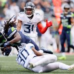 SEATTLE, WASHINGTON - SEPTEMBER 19: Running back Alex Collins #41 of the Seattle Seahawks is tackled by strong safety Bradley McDougald #30 of the Tennessee Titans during the second quarter at Lumen Field on September 19, 2021 in Seattle, Washington. (Photo by Steph Chambers/Getty Images)