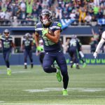 SEATTLE, WASHINGTON - SEPTEMBER 19: Wide receiver Freddie Swain #18 of the Seattle Seahawks is left wide open and scores a touchdown during the second half in the game against the Tennessee Titans at Lumen Field on September 19, 2021 in Seattle, Washington. (Photo by Abbie Parr/Getty Images)