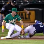 OAKLAND, CALIFORNIA - SEPTEMBER 21: Jarred Kelenic #10 of the Seattle Mariners slides into third base with a triple under the tag from Matt Chapman #26 of the Oakland Athletics in the top of the fourth inning at RingCentral Coliseum on September 21, 2021 in Oakland, California. (Photo by Thearon W. Henderson/Getty Images)