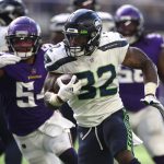 MINNEAPOLIS, MINNESOTA - SEPTEMBER 26: Chris Carson #32 of the Seattle Seahawks runs the ball for a touchdown during the second quarter in the game against the Minnesota Vikings at U.S. Bank Stadium on September 26, 2021 in Minneapolis, Minnesota. (Photo by David Berding/Getty Images)