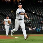 SEATTLE, WASHINGTON - SEPTEMBER 27: Chris Flexen #77 of the Seattle Mariners flips the ball to first base for an out in the second inning against the Oakland Athletics at T-Mobile Park on September 27, 2021 in Seattle, Washington. (Photo by Alika Jenner/Getty Images)
