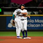 SEATTLE, WASHINGTON - SEPTEMBER 27: J.P. Crawford #3 and Abraham Toro #13 of the Seattle Mariners hug after a 13-4 win against the Oakland Athletics at T-Mobile Park on September 27, 2021 in Seattle, Washington.  (Photo by Alika Jenner/Getty Images)
