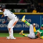 SEATTLE, WASHINGTON - SEPTEMBER 29: Ty France #23 of the Seattle Mariners is safe at second base on a fielding error by Josh Harrison #1 of the Oakland Athletics at T-Mobile Park on September 29, 2021 in Seattle, Washington. (Photo by Alika Jenner/Getty Images)