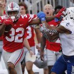
              Ohio State running back TreVeyon Henderson, left, stiff-arms Tulsa defensive back Travon Fuller during the second half of an NCAA college football game Saturday, Sept. 18, 2021, in Columbus, Ohio. (AP Photo/Jay LaPrete)
            