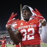 
              Houston safety Gervarrius Owens (32) reacts to defeating Navy in an NCAA college football game Saturday, Sept. 25, 2021, in Houston. Houston won, 28-20. (AP Photo/Justin Rex)
            