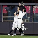 
              New York Yankees right fielder Aaron Judge, right, makes a catch in front of Brett Gardner on a ball hit by Minnesota Twins' Miguel Sano during the 10th inning of a baseball game on Monday, Sept. 13, 2021, in New York. (AP Photo/Adam Hunger)
            