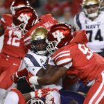 
              Navy quarterback Maasai Maynor (9) is sacked by Houston defensive lineman Atlias Bell (93) during the second half of an NCAA college football game Saturday, Sept. 25, 2021, in Houston. (AP Photo/Justin Rex)
            
