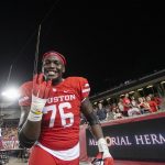 
              Houston offensive lineman Patrick Paul (76) reacts to defeating Navy in an NCAA college football game Saturday, Sept. 25, 2021, in Houston. Houston won, 28-20. (AP Photo/Justin Rex)
            