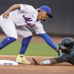 
              New York Mets' Francisco Lindor, left, tags out out Miami Marlins' Jesus Sanchez as he attempts to steal second base during the first inning in the first baseball game of a doubleheader Tuesday, Sept. 28, 2021, in New York. (AP Photo/Frank Franklin II)
            