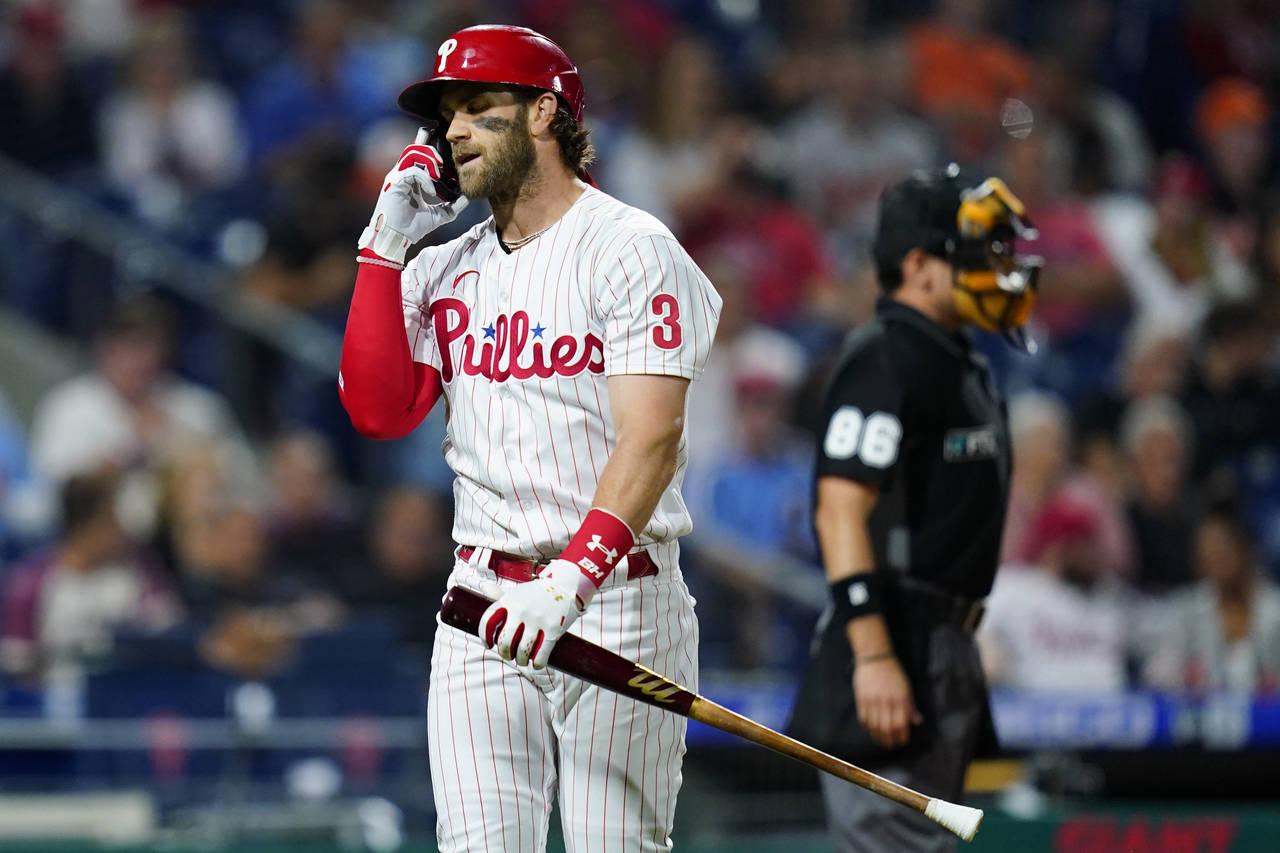 Philadelphia Phillies' Bryce Harper reacts after striking out against Baltimore Orioles pitcher Joh...