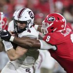 
              South Carolina quarterback Luke Doty (4) is tackled by Georgia linebacker MJ Sherman (8) during the second half of an NCAA college football game Saturday, Sept. 18, 2021, in Athens, Ga. Georgia won 40-13. (AP Photo/Butch Dill)
            