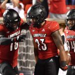 
              Louisville running back Trevion Cooley (23) celebrates with wide receiver Justin Marshall (18) and tight end Dez Melton (84) following his touchdown during the second half of an NCAA college football game against Central Florida in Louisville, Ky., Friday, Sept. 17, 2021. (AP Photo/Timothy D. Easley)
            