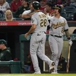 
              Oakland Athletics' Matt Olson (28) celebrates with Yan Gomes after scoring off of a ground out by Seth Brown during the sixth inning of a baseball game against the Los Angeles Angels Friday, Sept. 17, 2021, in Anaheim, Calif. (AP Photo/Ashley Landis)
            